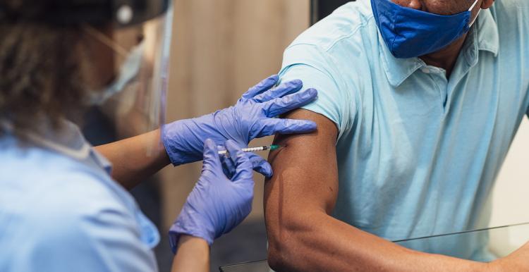 man receiving Covid vaccine 