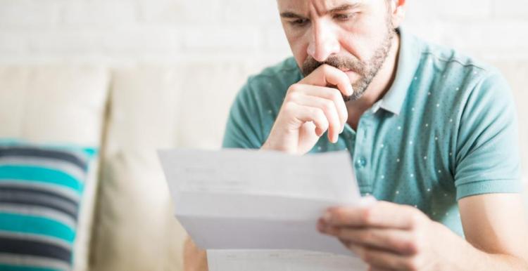 Man reading letter or form 