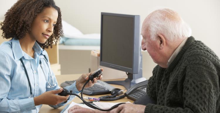 Female GP with older patient 