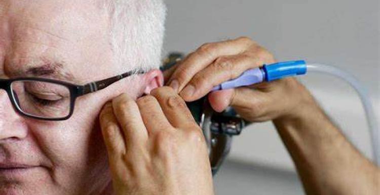 man having ear syringed 