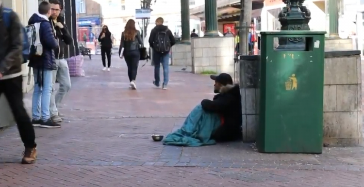 homeless man on a busy street