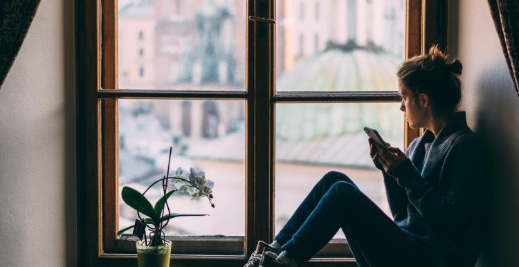 woman-looking-out-of-a-window