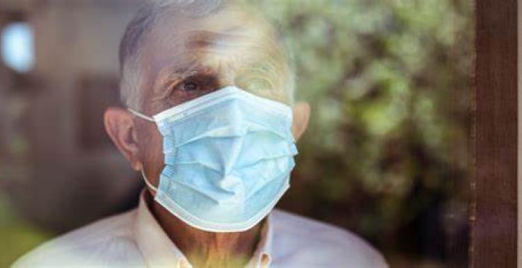 older man wearing a face mask 