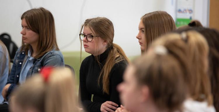 Group of young people sitting and listening 