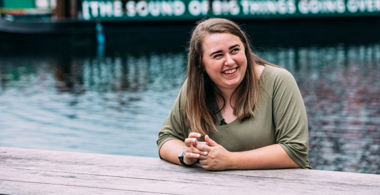 Young woman outside next to a canal 