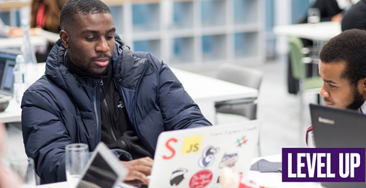 Two young men on laptops 