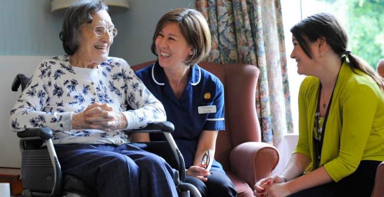 Care setting resident with visitor and care professional