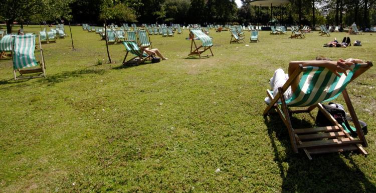 people in the sun on deckchairs 