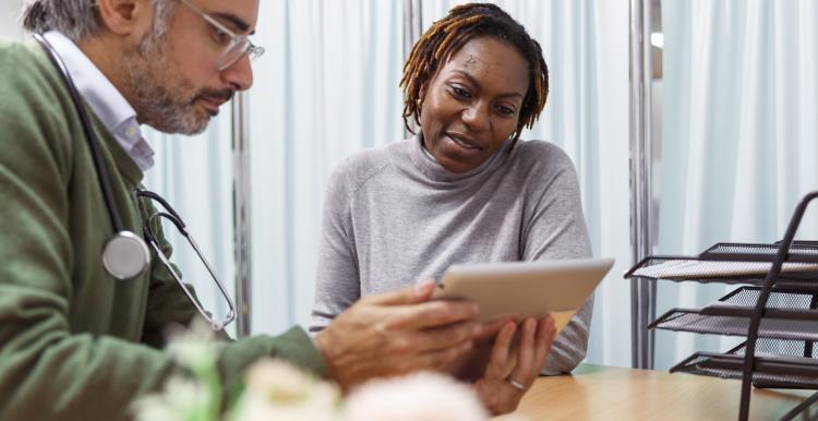 Patient sat with a GP viewing some electronic information