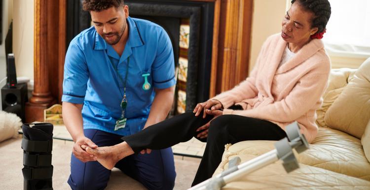 Health professional looking at patients foot 