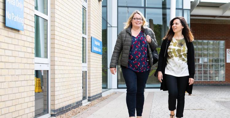 Women walking outside of a hospital