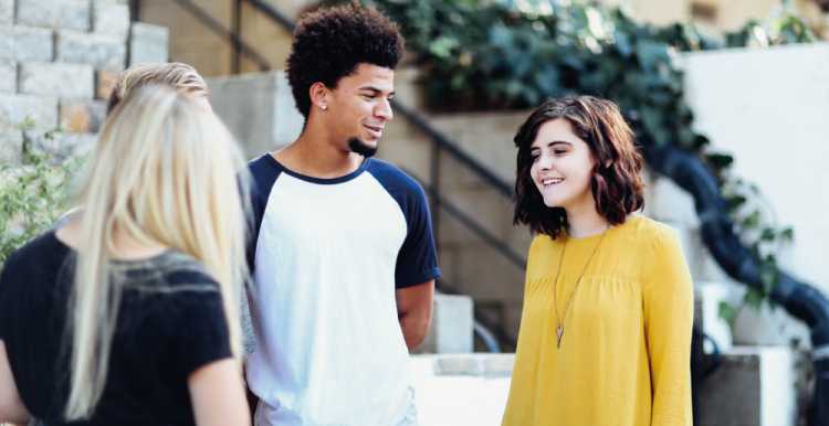 young man and two young women talking 