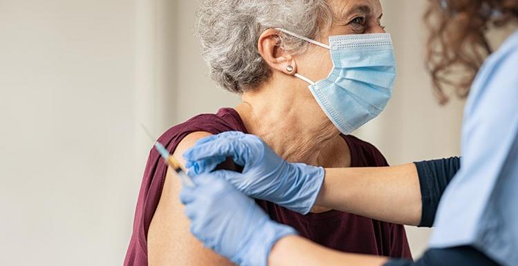 older lady having vaccine 