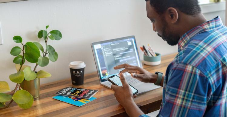 man on phone and computer