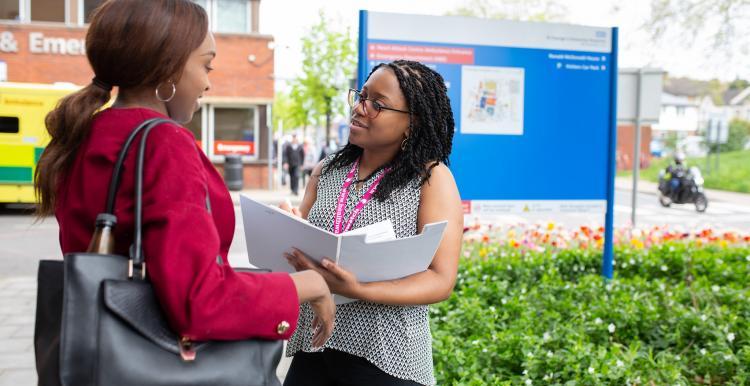 Healthwatch staff member talking to a woman