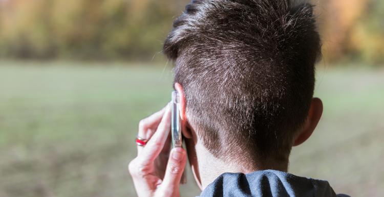 A picture of a person making a call on a mobile phone