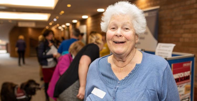 older lady with other women in the background 