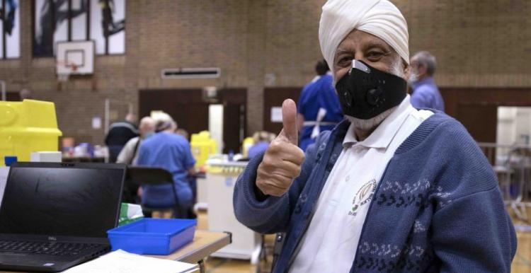 man wearing mask in vaccine centre 