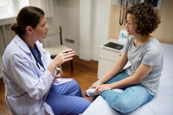young_woman_with_doctor_in_exam_room