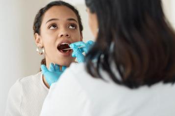 Dentist looking in patients mouth 