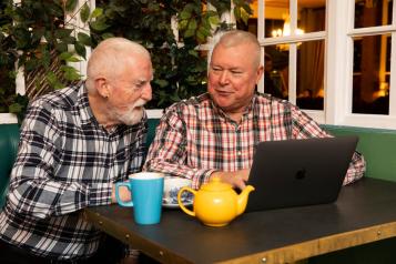 Two men on a laptop