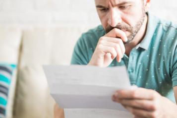 Man reading letter or form 