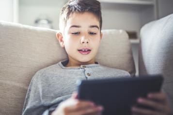 boy looking at a laptop 