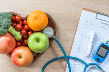 diabetes kit and heart shaped fruit 