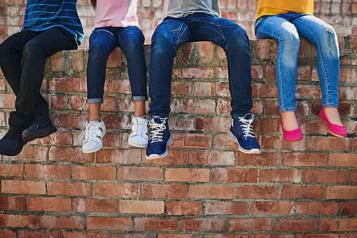 young people sat on a wall