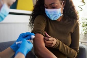 young woman having vaccine 