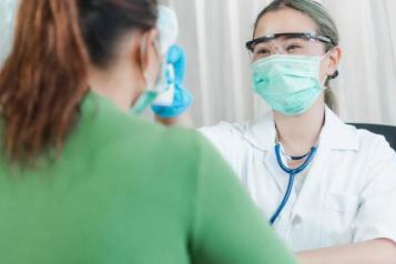 A female dental surgeon talking to a patient 