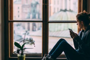 woman-looking-out-of-a-window