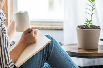 women_sat_witing_in_notebook