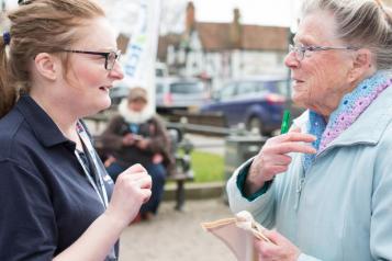 person talking to member of Healthwatch staff
