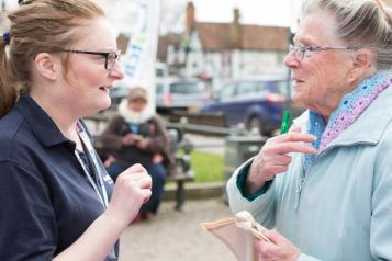 person talking to member of Healthwatch staff 