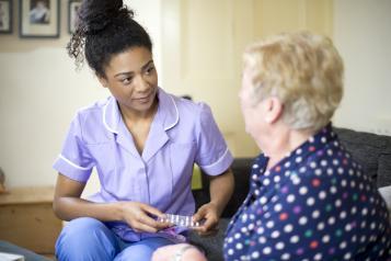 older woman talking to a nurse 