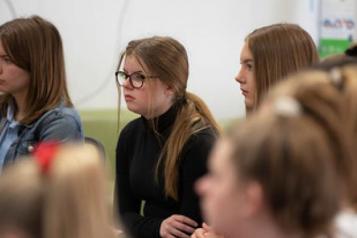 Group of young people sitting and listening 