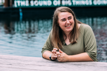 Young woman outside next to a canal 