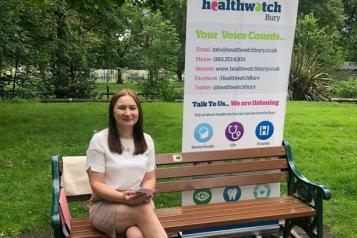 Healthwatch staff member sat on park bench 
