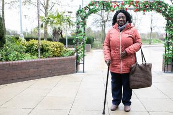 lady outdoors with walking stick 