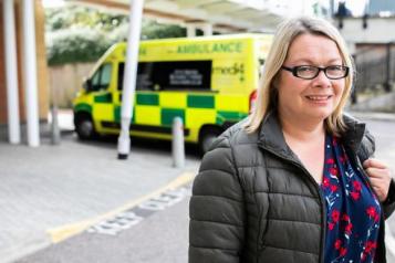 Woman in front of an ambulance 