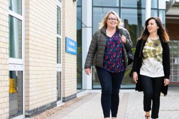 Women walking outside of a hospital