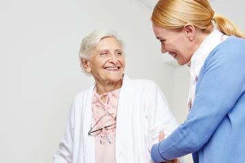 Older lady supported by carer