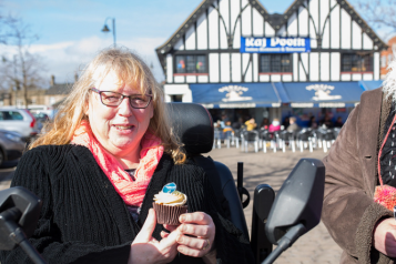 lady in a wheelchair with a cupcake 