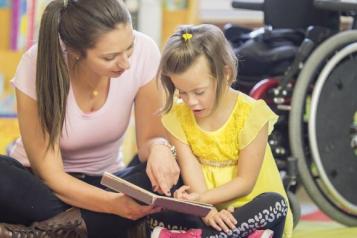 Carer reading with child 
