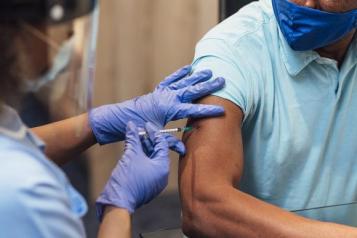 man receiving Covid vaccine 