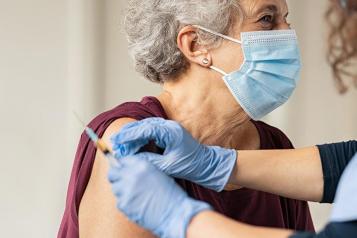 older lady having vaccine 