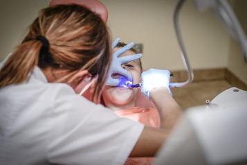 dentist looking into childs mouth 