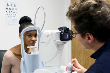 Young woman attending eye screening 