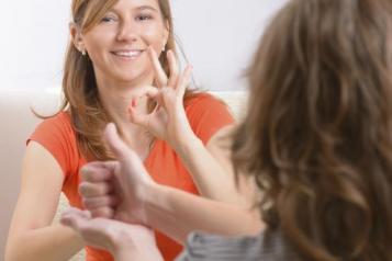 Two young women using sign language 